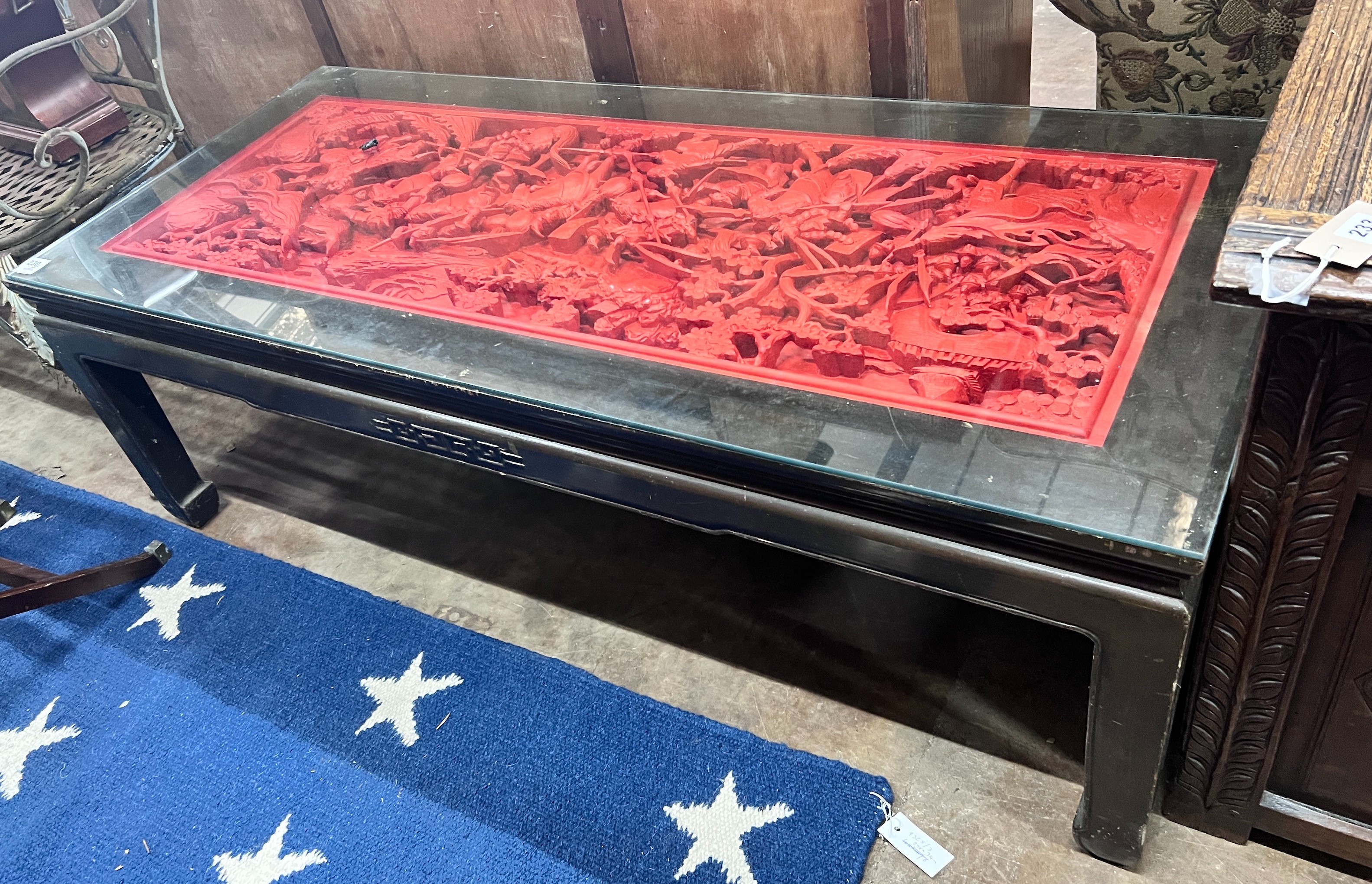 An Asian red stained hardwood coffee table, length 142cm *Please note the sale commences at 9am.